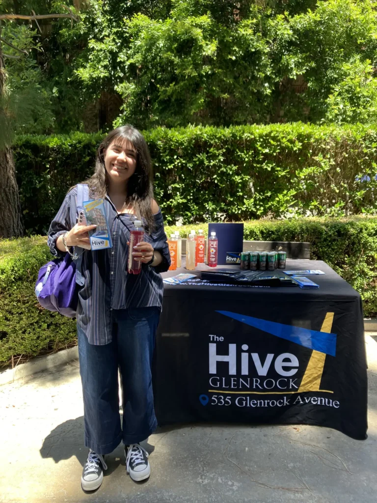 Student receiving drinks and information at The Hive Glenrock stand - Luxury apartments near UCLA