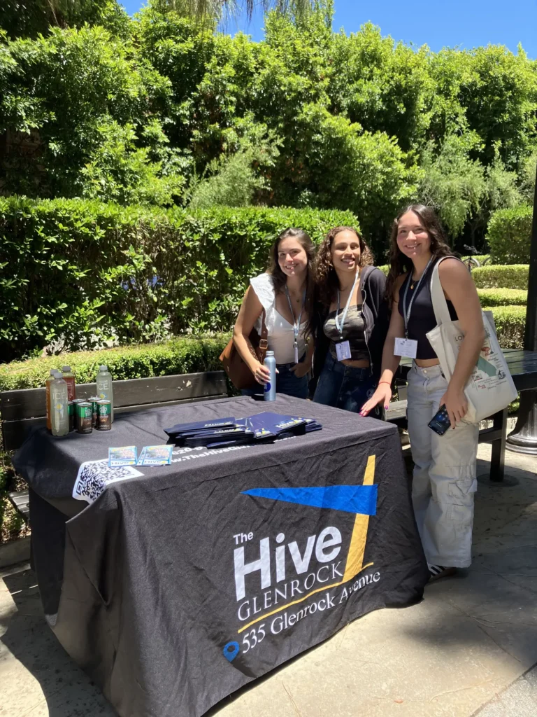 Students standing in front of The Hive Glenrock stand at an event