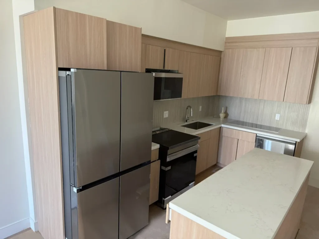 Brand new kitchens with oak cabinetry and quartz countertops at The Hive Glenrock - Housing near UCLA